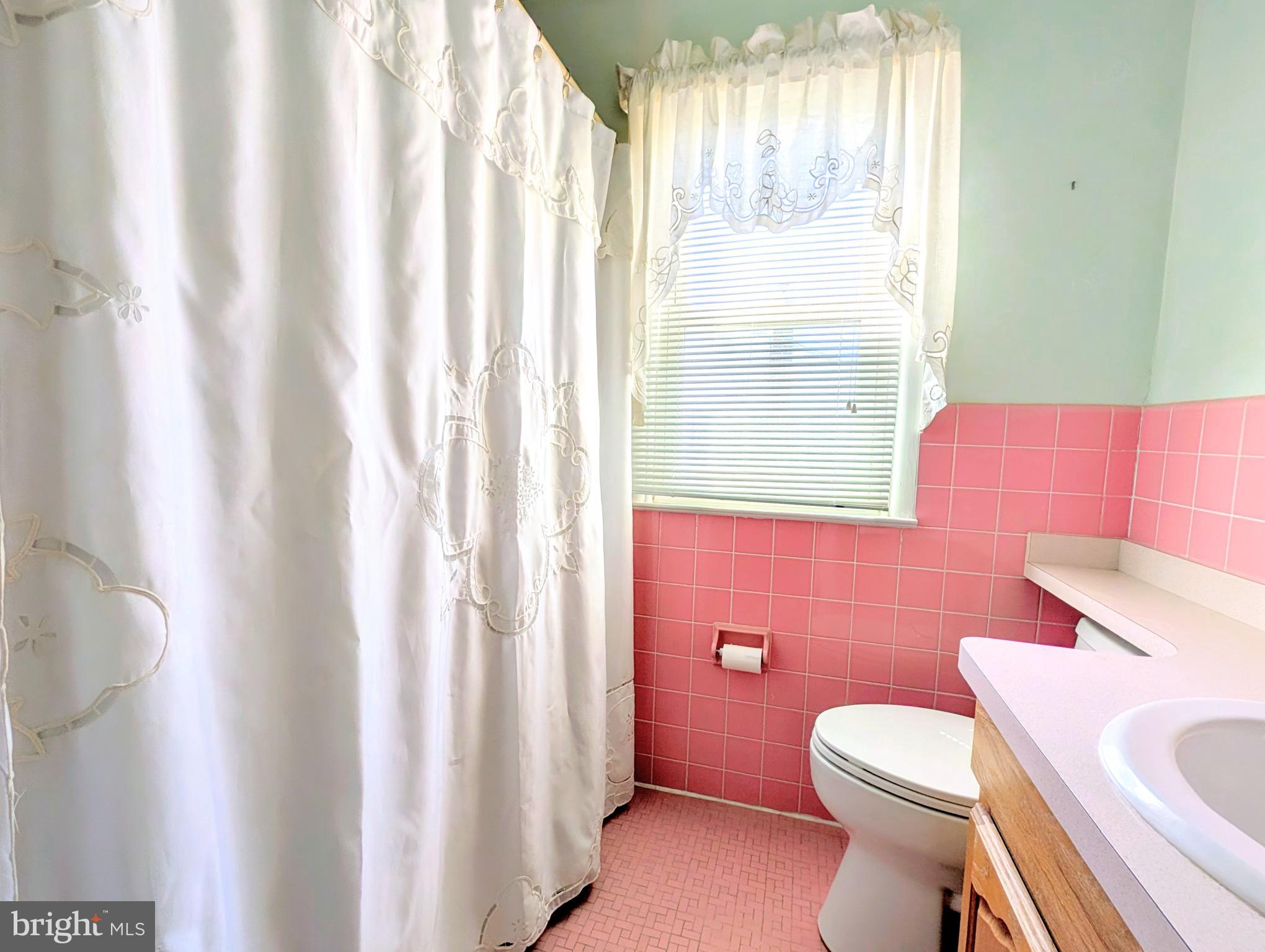 1439 Michigan Avenue Swarthmore, PA 19081 - Photo 28 of 54 a white toilet sitting next to a bathroom sink