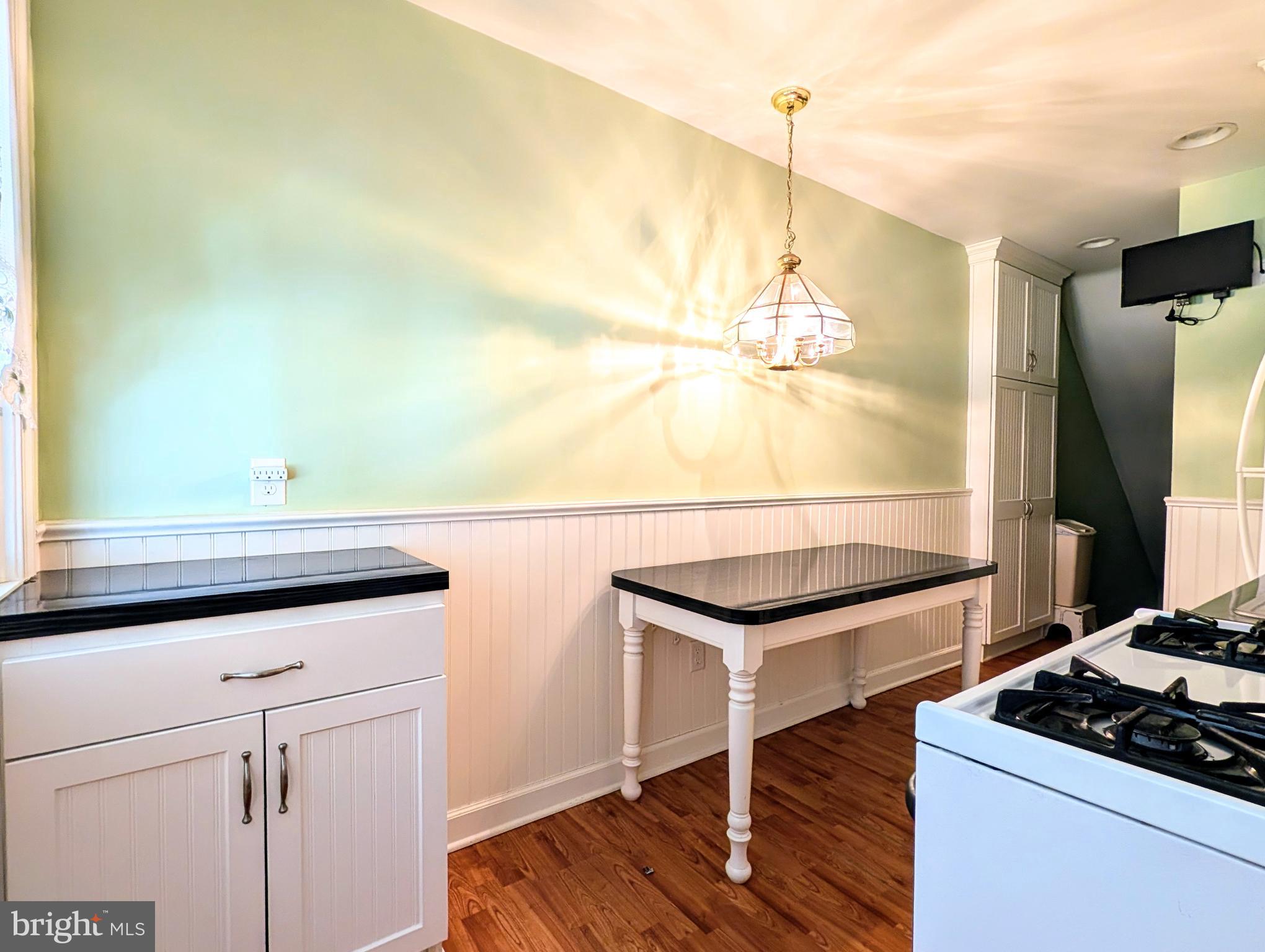 1439 Michigan Avenue Swarthmore, PA 19081 - Photo 35 of 54 a kitchen with kitchen island a sink cabinets and wooden floor