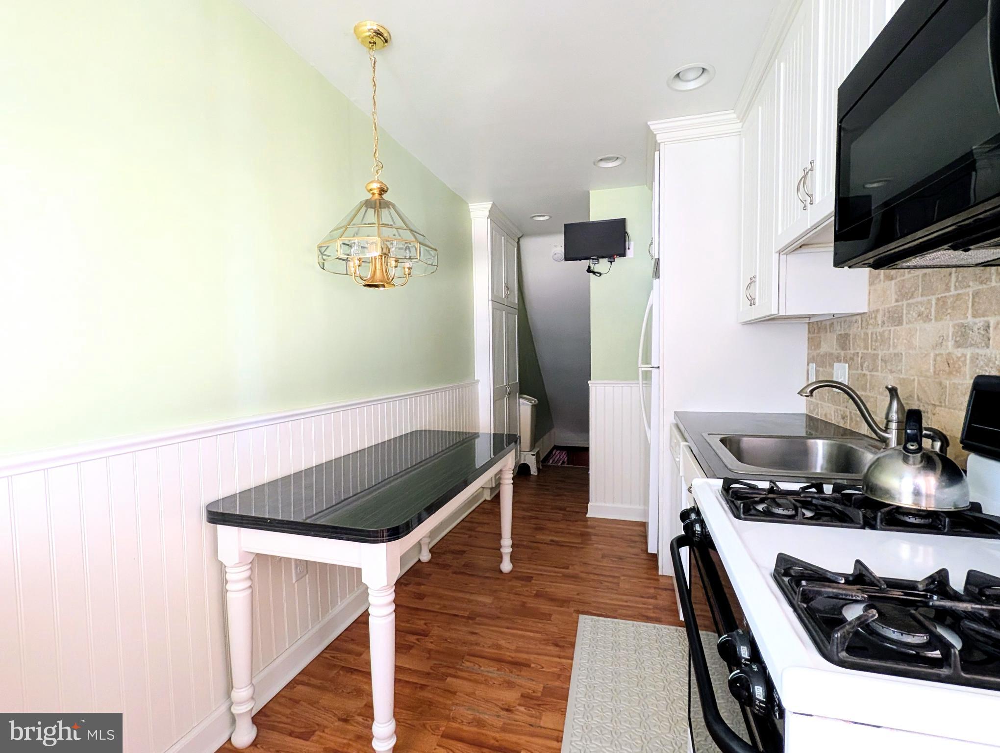1439 Michigan Avenue Swarthmore, PA 19081 - Photo 36 of 54 a kitchen with stainless steel appliances granite countertop a sink stove and refrigerator