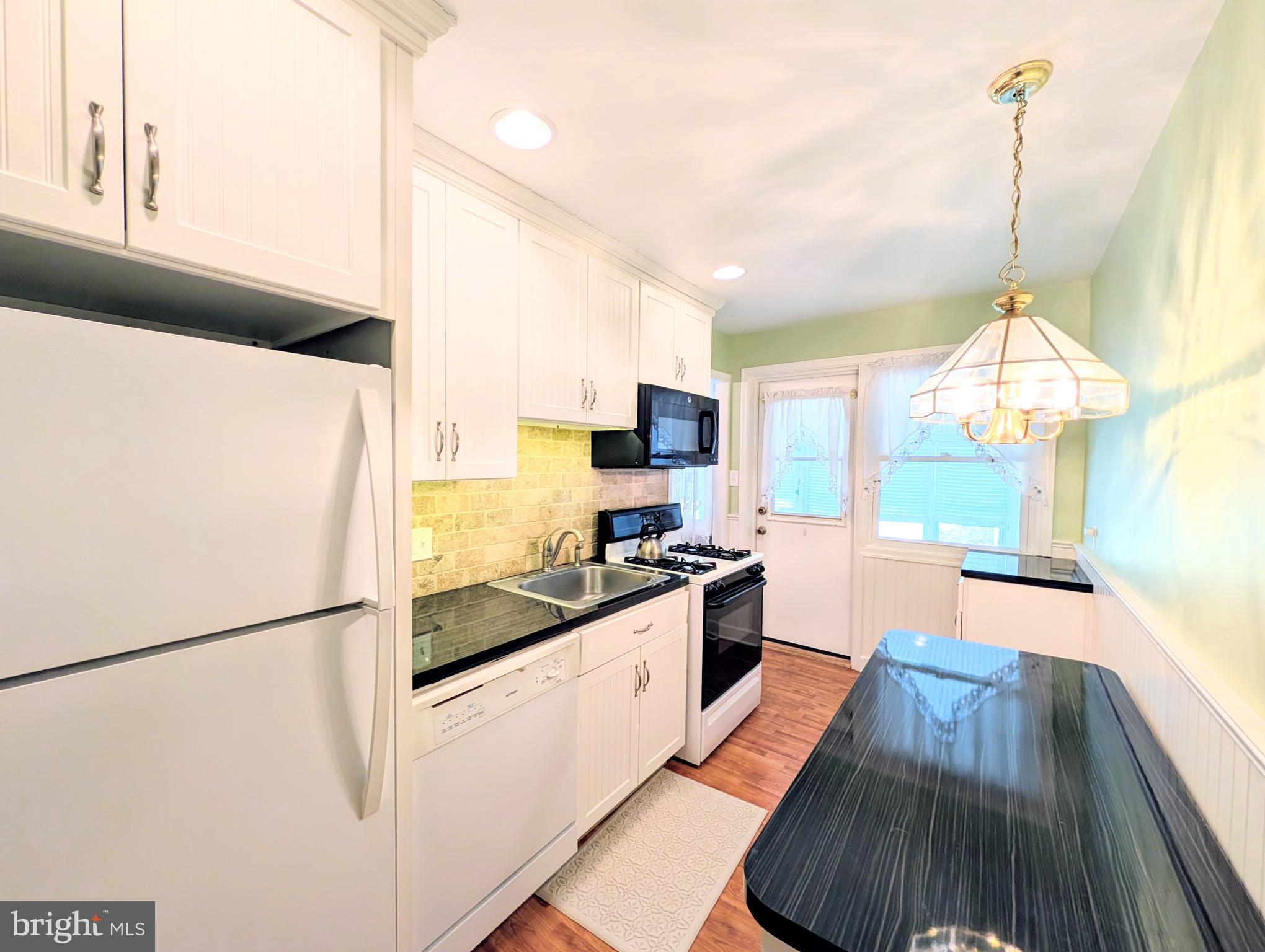 1439 Michigan Avenue Swarthmore, PA 19081 - Photo 39 of 54 a kitchen with stainless steel appliances a stove a refrigerator and a sink