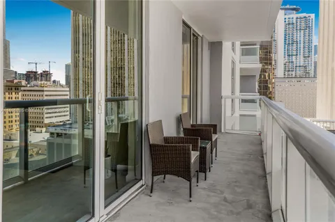 a view of a kitchen with a sink and refrigerator