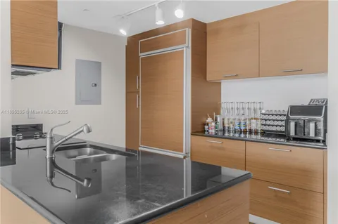 a kitchen with a sink and a refrigerator