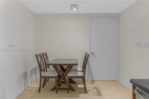 a view of a workspace with furniture and wooden floor