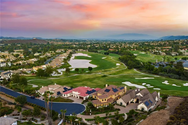 a view of a lake with a yard and potted plants