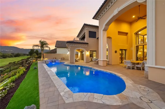 a living room with furniture a chandelier and potted plant