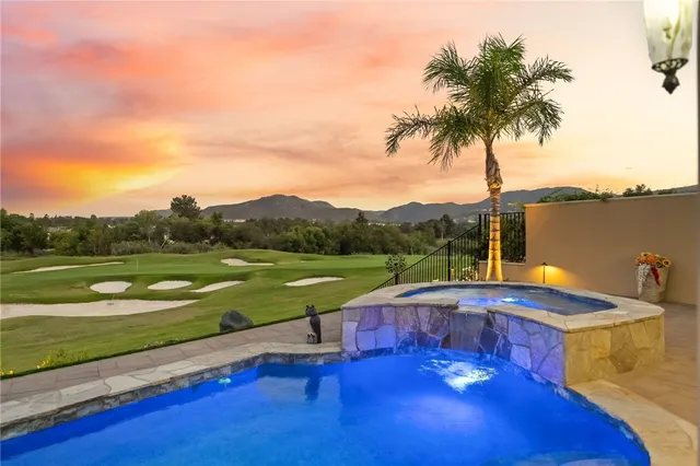 a living room with furniture a large window and a fireplace