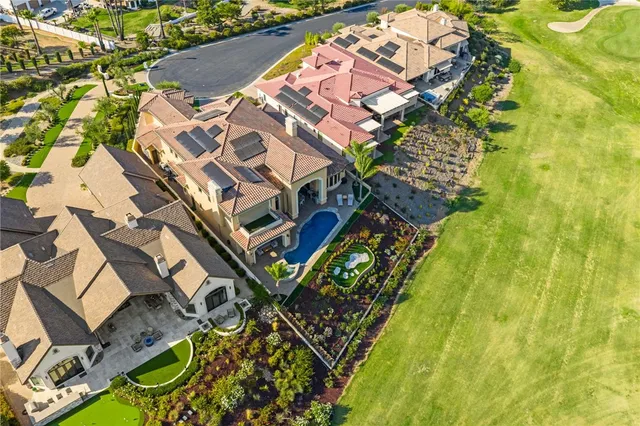 an open kitchen with granite countertop a stove and white cabinets