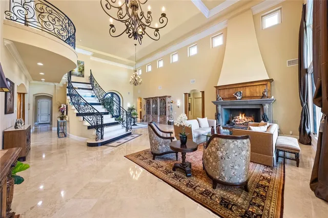 a living room with furniture fireplace and a large window