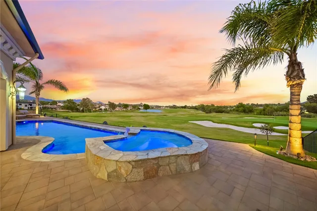 a view of a hallway with wooden floor and front door