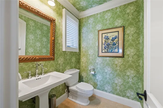 a bathroom with a granite countertop sink a toilet and a mirror