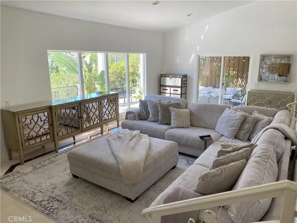 a living room with furniture and kitchen view