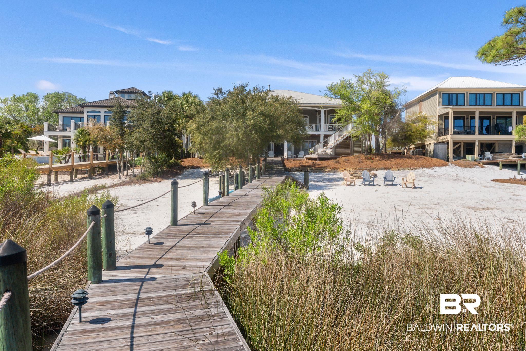 30818 River Road Orange Beach, AL 36561 - Photo 6 of 81 Rear view of house featuring a water view and a patio
