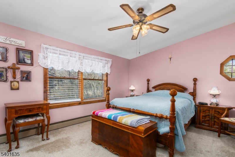 37 Ward Road Blairstown, NJ 07825 - Photo 15 of 28 a bedroom with a bed and a chandelier