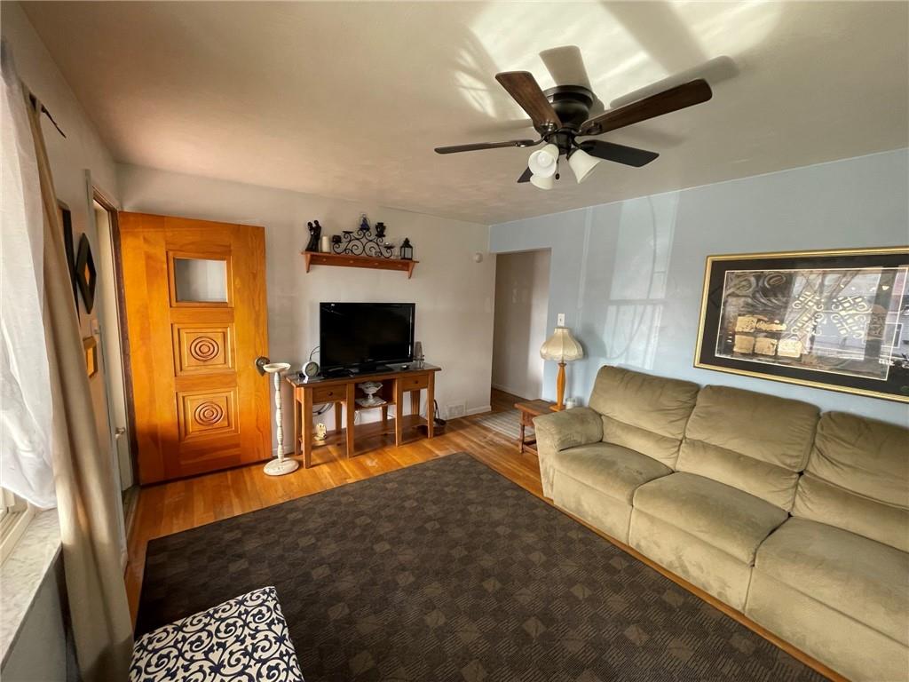 63 Locust Street McKees Rocks, PA 15136 - Photo 5 of 25 a living room with furniture and a flat screen tv
