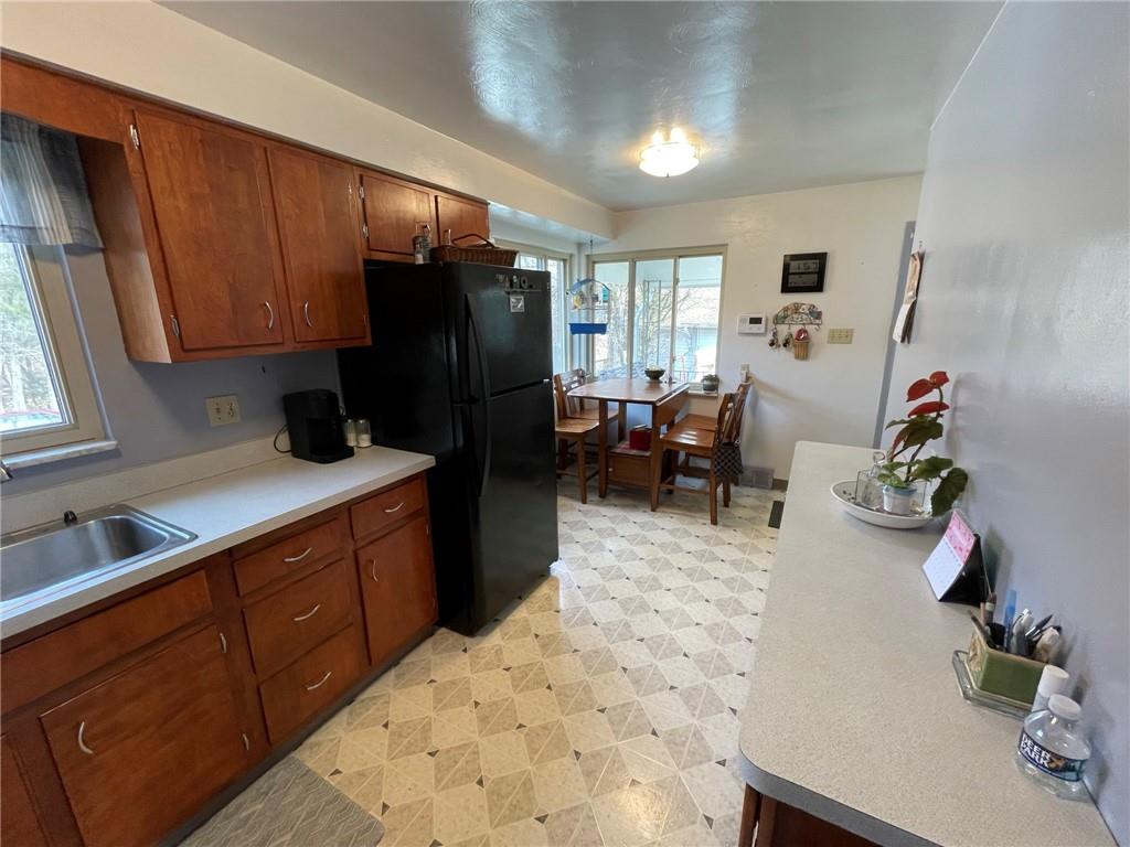 63 Locust Street McKees Rocks, PA 15136 - Photo 7 of 25 a kitchen with stainless steel appliances wooden cabinets a stove top oven a sink and dishwasher