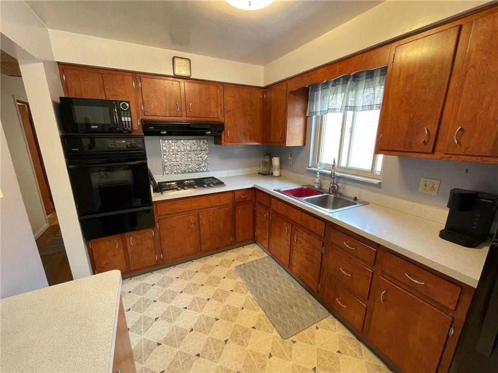 63 Locust Street McKees Rocks, PA 15136 - Photo 8 of 25 a kitchen with stainless steel appliances a sink stove and cabinets