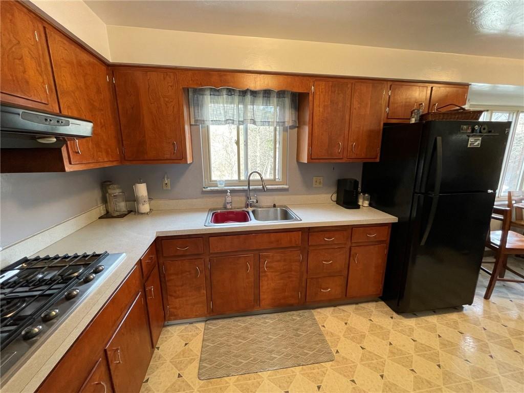 63 Locust Street McKees Rocks, PA 15136 - Photo 9 of 25 a kitchen with stainless steel appliances granite countertop a refrigerator stove and sink