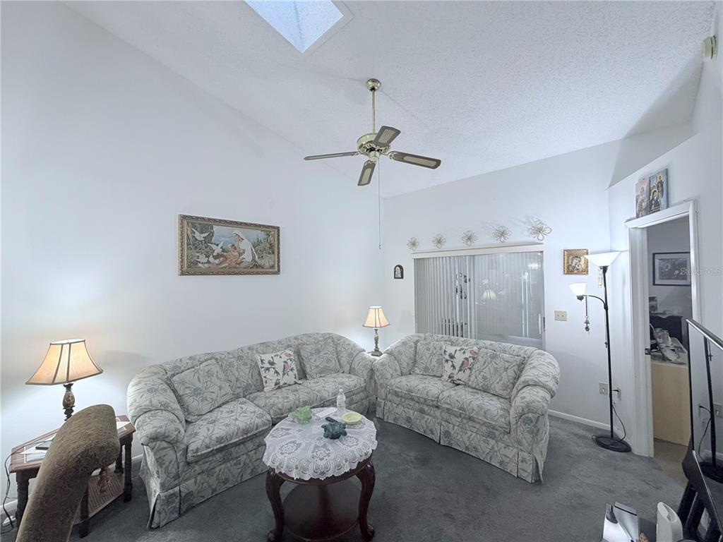 4523 Glen Hollow New Port Richey, FL 34653 - Photo 12 of 62 a living room with furniture and a ceiling fan