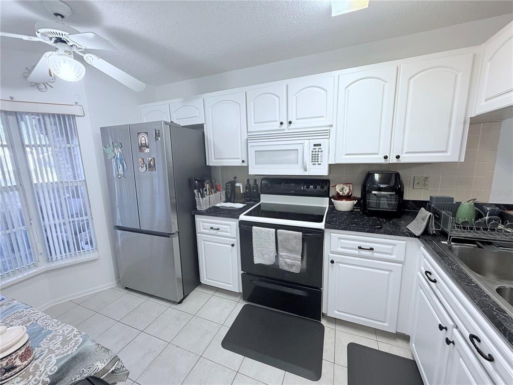 4523 Glen Hollow New Port Richey, FL 34653 - Photo 16 of 62 a kitchen with cabinets and appliances