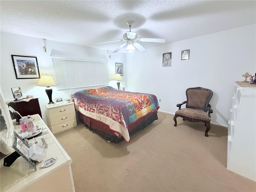 4523 Glen Hollow New Port Richey, FL 34653 - Photo 24 of 62 a spacious bedroom with a bed and a couch