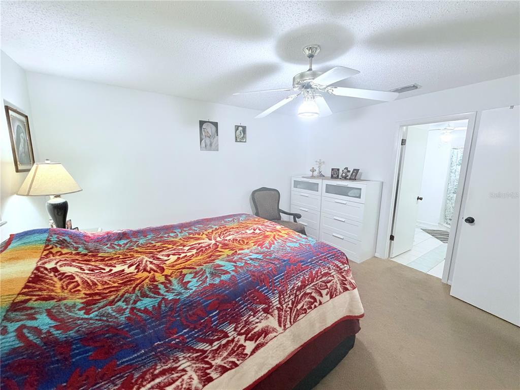 4523 Glen Hollow New Port Richey, FL 34653 - Photo 27 of 62 a bedroom with a bed and a chandelier