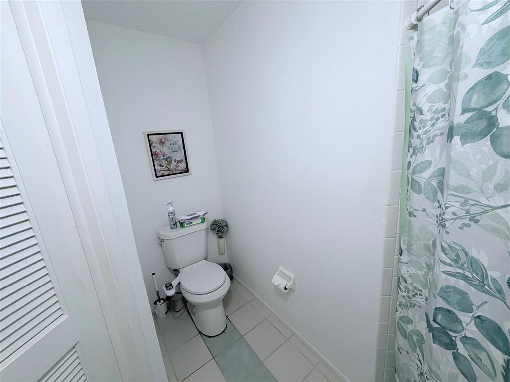 4523 Glen Hollow New Port Richey, FL 34653 - Photo 32 of 62 a bathroom with a toilet and a shower curtain