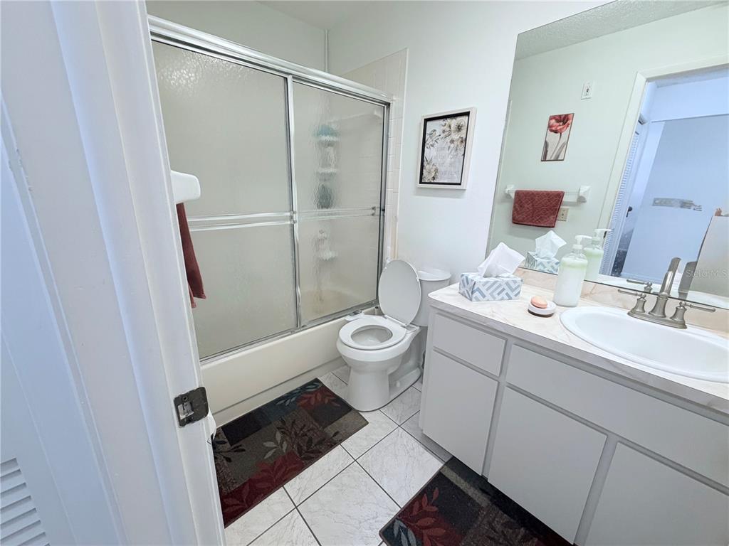 4523 Glen Hollow New Port Richey, FL 34653 - Photo 38 of 62 a bathroom with a granite countertop sink toilet and shower
