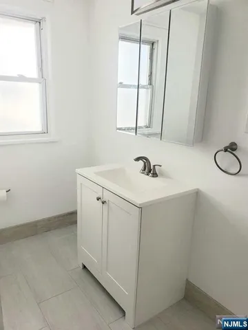 a bathroom with a sink a vanity and a mirror
