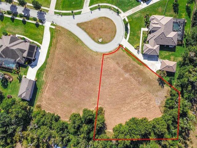 an aerial view of a house with swimming pool and outdoor seating