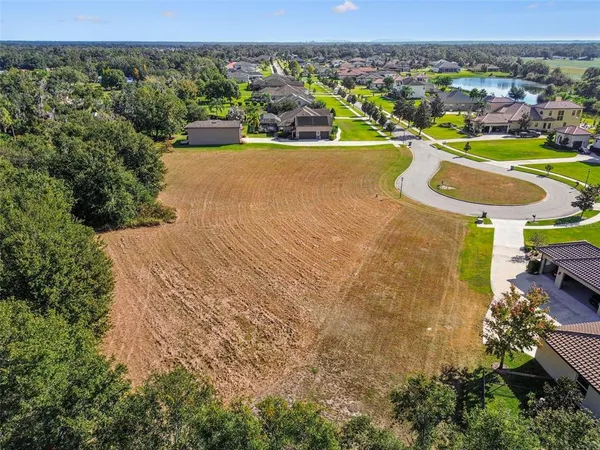 an aerial view of a house with yard swimming pool and outdoor seating