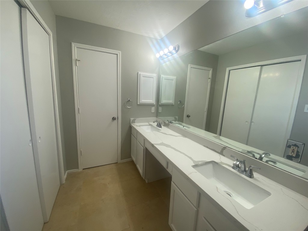 14007 Oleoke Lane Houston, TX 77015 - Photo 11 of 19 a bathroom with a double vanity sink and a mirror
