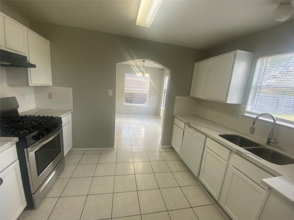 14007 Oleoke Lane Houston, TX 77015 - Photo 6 of 19 a kitchen with a sink a stove and cabinets