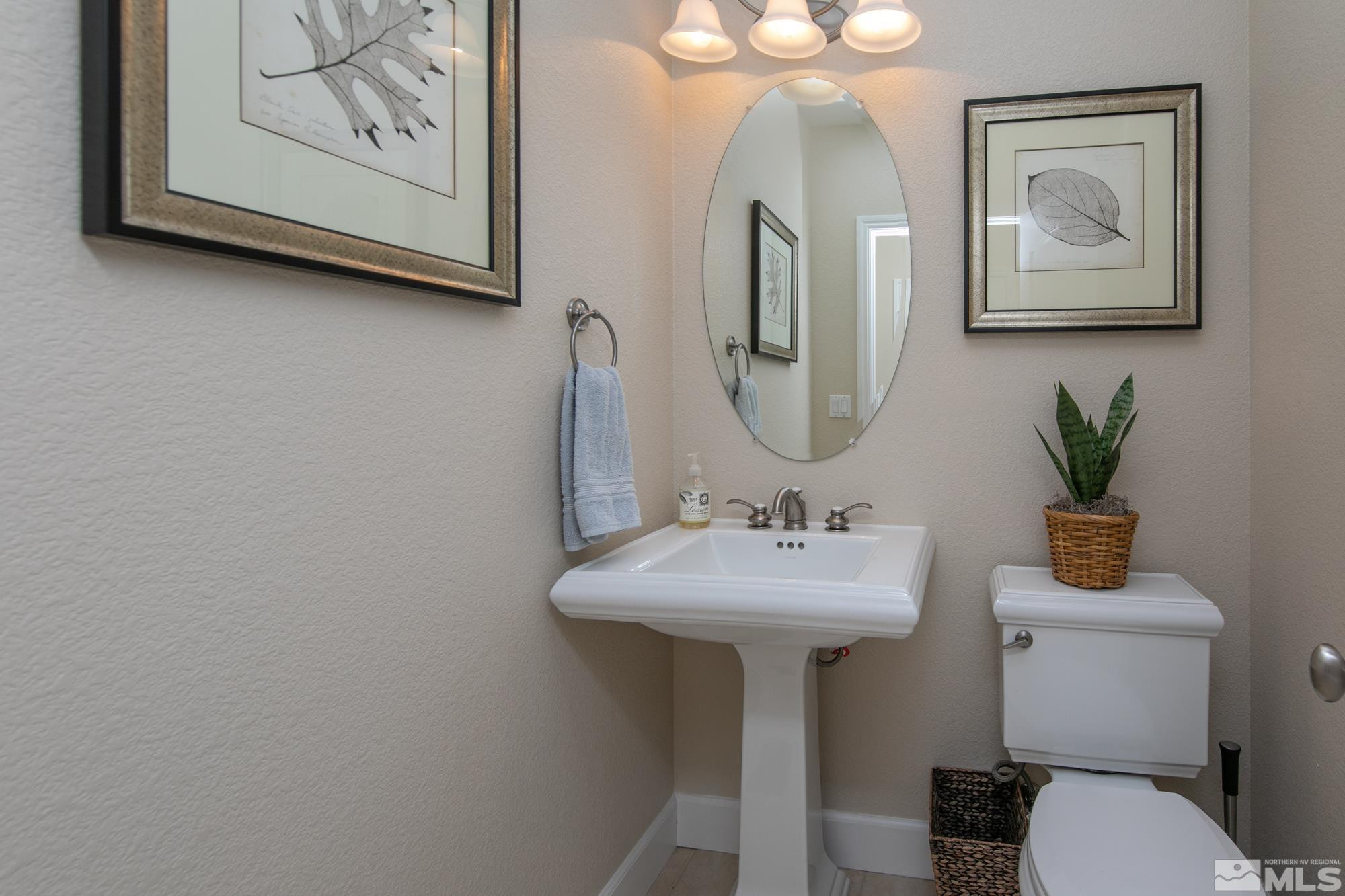 8573 Timaru Trail Reno, NV 89523 - Photo 17 of 40 a bathroom with a toilet sink and mirror