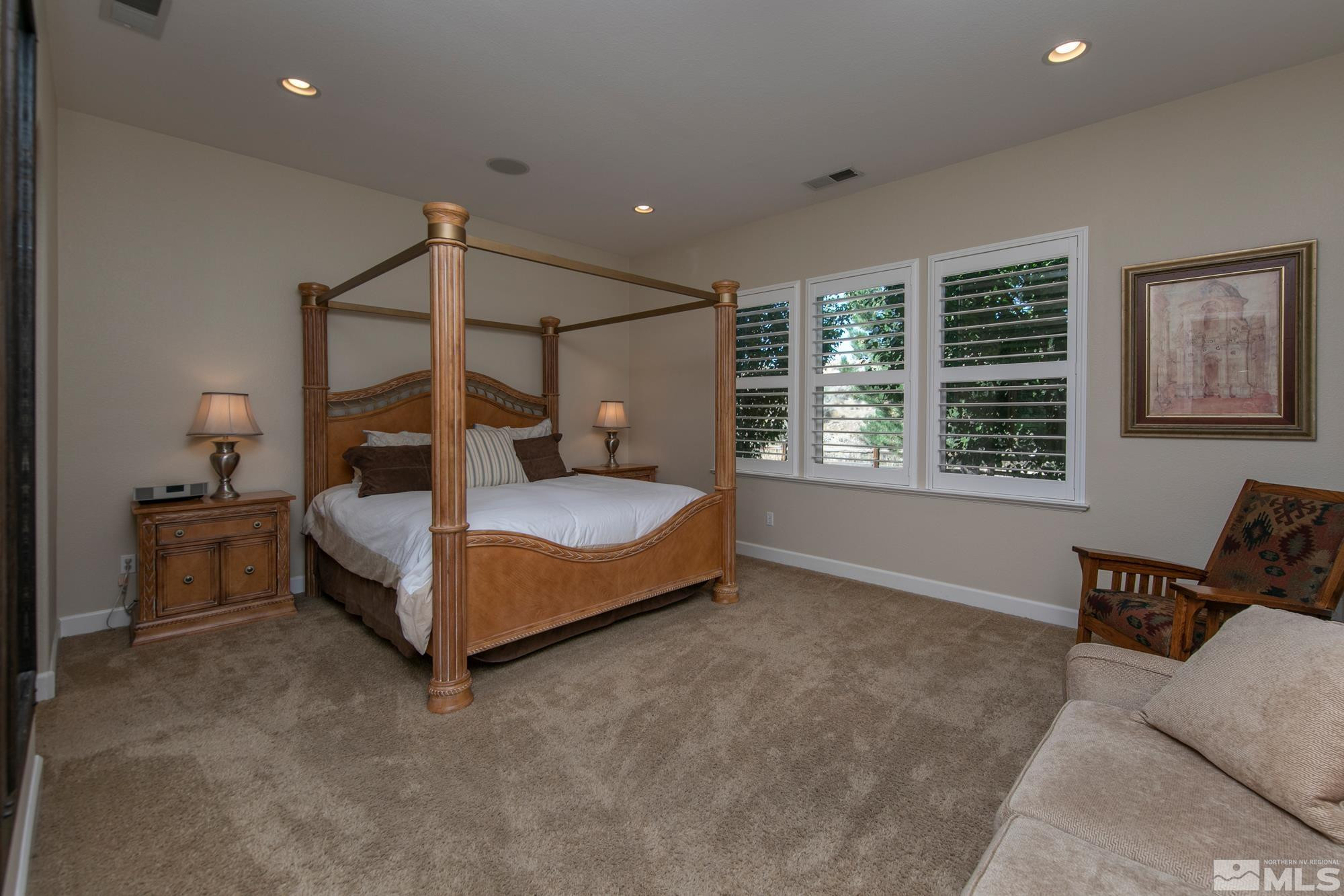 8573 Timaru Trail Reno, NV 89523 - Photo 18 of 40 a spacious bedroom with a bed and a window