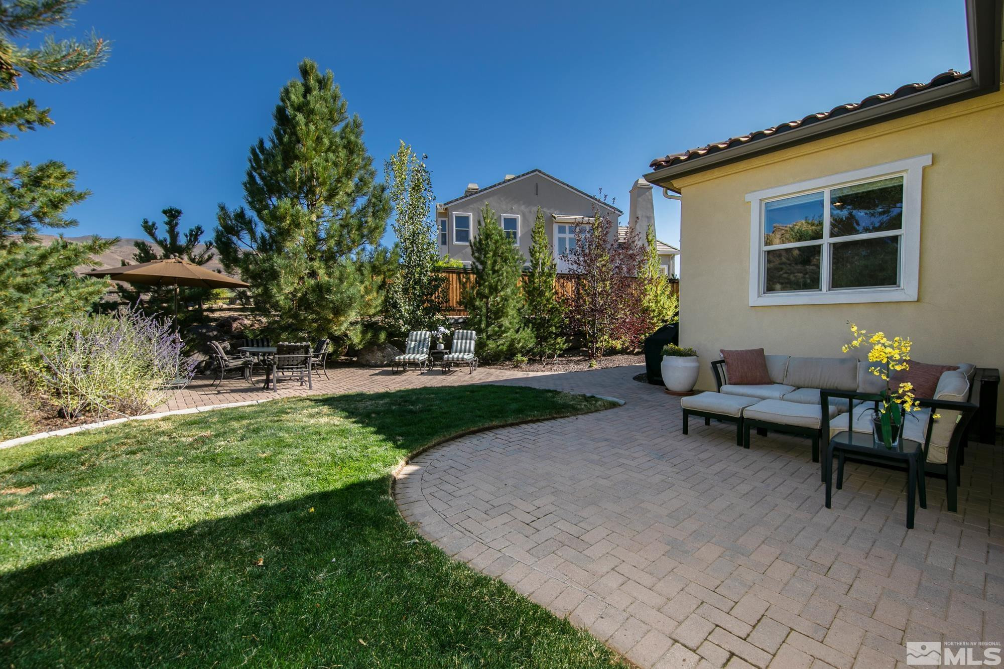 8573 Timaru Trail Reno, NV 89523 - Photo 33 of 40 a view of a patio with couches table and chairs and potted plants