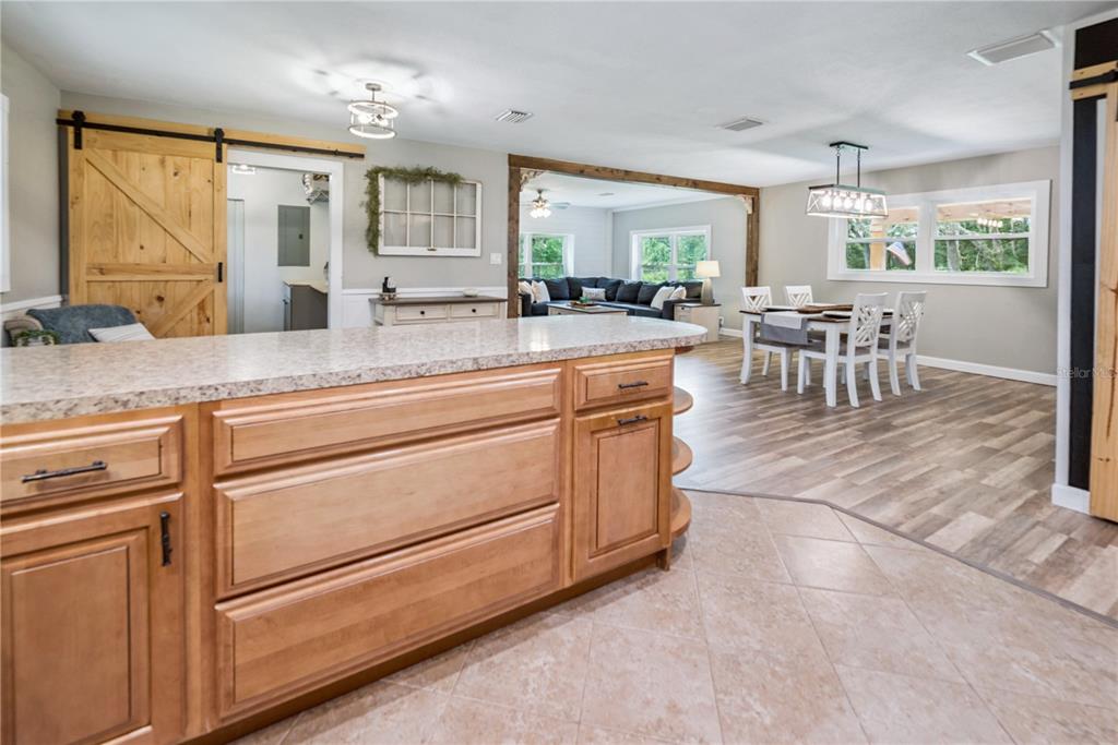 14545 Southwest 155th Avenue Brooker, FL 32622 - Photo 12 of 44 a living room with kitchen island granite countertop furniture and a large window