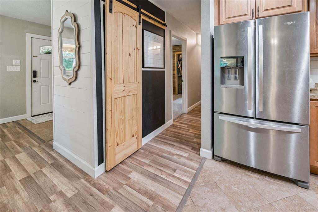 14545 Southwest 155th Avenue Brooker, FL 32622 - Photo 23 of 44 a kitchen with stainless steel appliances a refrigerator and a wooden floor