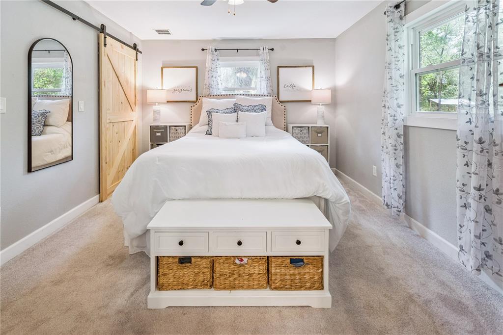 14545 Southwest 155th Avenue Brooker, FL 32622 - Photo 27 of 44 a bedroom with a bed mirror and window