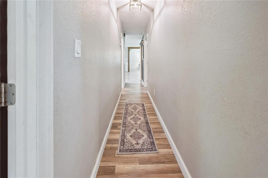 14545 Southwest 155th Avenue Brooker, FL 32622 - Photo 30 of 44 a view of a hallway with wooden floor