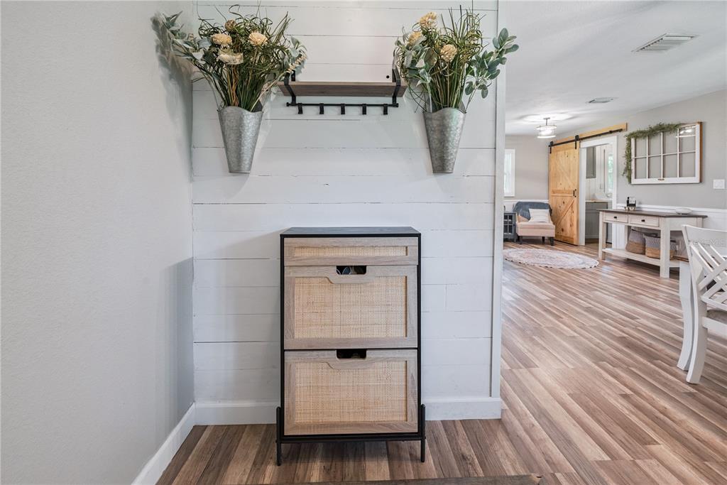 14545 Southwest 155th Avenue Brooker, FL 32622 - Photo 3 of 44 a view of a hallway with wooden floor and a potted plant