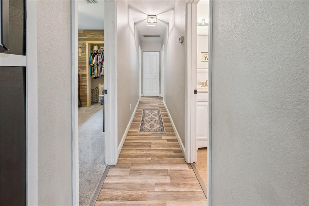 14545 Southwest 155th Avenue Brooker, FL 32622 - Photo 31 of 44 a view of a hallway with wooden floor and a bathroom