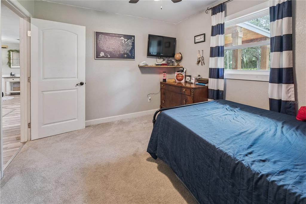 14545 Southwest 155th Avenue Brooker, FL 32622 - Photo 34 of 44 a living room with furniture and a flat screen tv