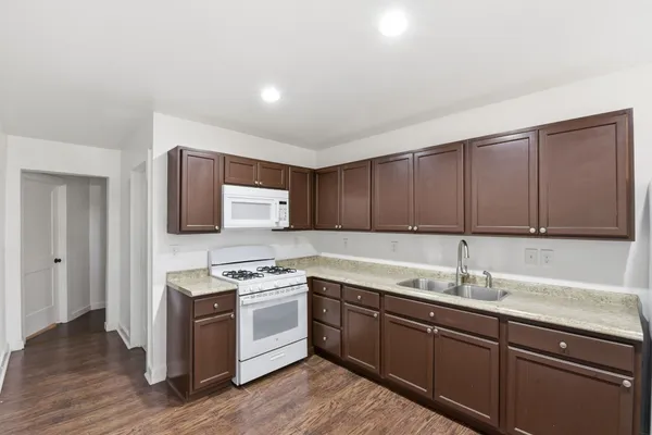 a kitchen with a sink cabinets and stainless steel appliances