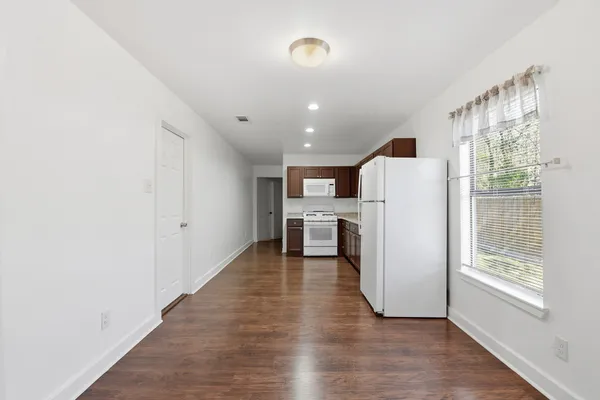 a view of kitchen with furniture and wooden floor