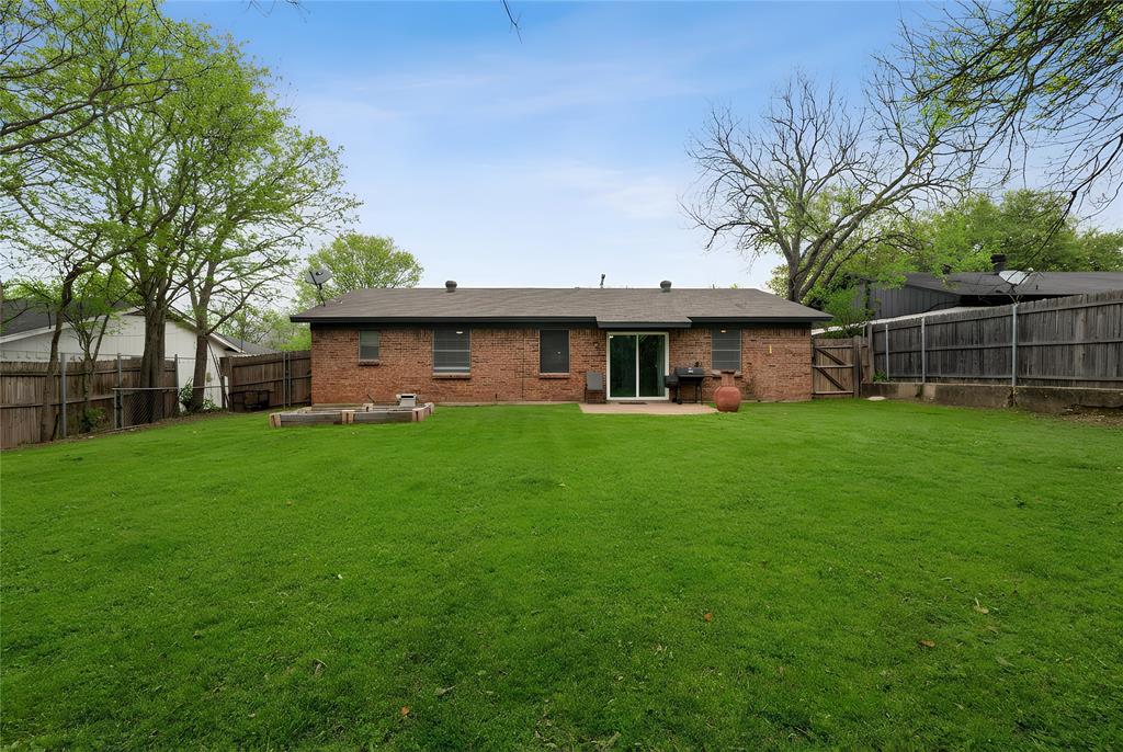 6020 Harrison Way Watauga, TX 76148 - Photo 29 of 32 Rear view of house with a patio area, brick siding, a fenced backyard, and a gate