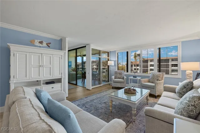 a living room with furniture and a floor to ceiling window