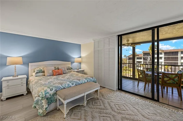 a bedroom with a bed and dresser with mirror