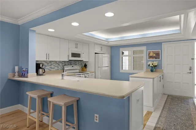 a kitchen with a stove a sink and a refrigerator