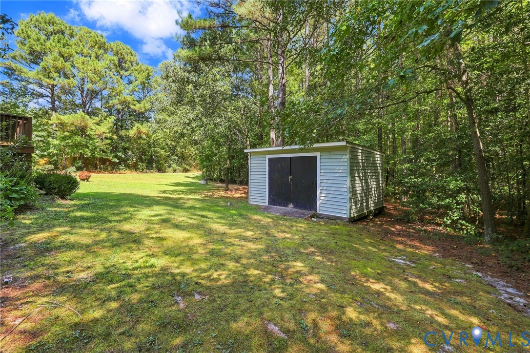 16753 Jolly Road Disputanta, VA 23842 - Photo 43 of 44 Expansive grassy yard with mature trees and a deta