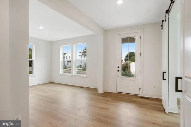 an empty room with a window and wooden floor